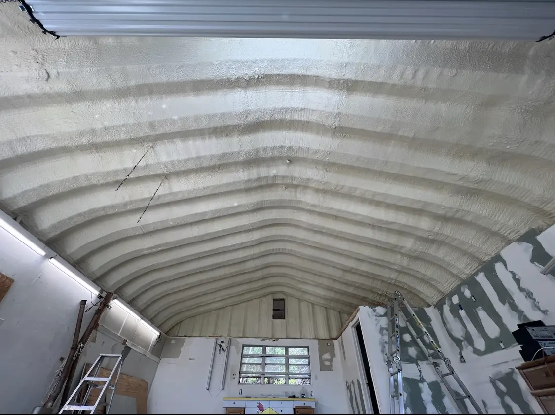 Spray polyurethane foam applied to the underside of a metal roof deck in Waxhaw